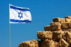 Israeli flag flying against blue sky