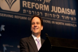 Rabbi Jonah Pesner speaking from a podium