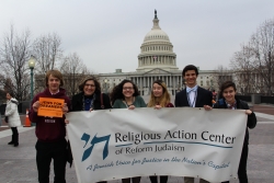 Teens and Rabbi stand in front of the US Capitol Building 
