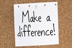 Make a difference sign tacked to a cork board
