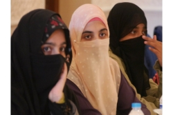 Three Muslim women with traditional head coverings