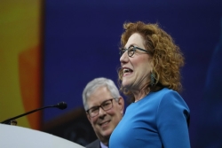 Cantor Barbara Ostfeld smiles on stage as she accepts her award