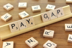 scrabble pieces spelling pay gap