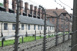 View through barbed wire at barracks as in a concentration camp 