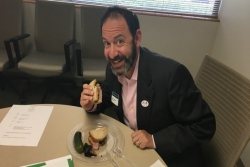 Houston Rabbi Oren Hayon eating a deli sandwich sent from Stephen Wise Temple in Los Angeles after the Houston Astros won the World Series