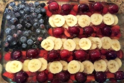American flag dessert made out of blueberries bananas and strawberries