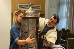 The author (wearing tefillin) and a student with a Sephardic Torah scroll