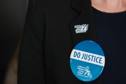 Closeup of the buttons on a persons blazer that read DO JUSTICE and RELIGIOUS ACTION CENTER OF REFORM JUDAISM