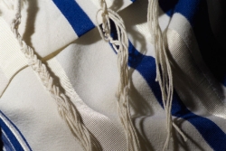 Closeup of a blue and white prayer shawl