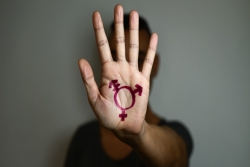 Transgender symbol painted on young person's palm