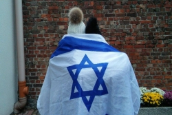 Two students, backs to the camera, wrapped together in an Israeli flag
