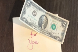 Envelope containing a note from Renee and a two dollar bill