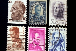 Six postage stamps honoring five U.S. presidents: FDR, Teddy Roosevelt, Washington, JFK, Lincoln, and Washington