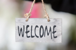 Rustic looking welcome sign hanging from twine