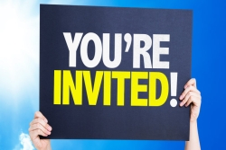 Sign that says You're Invited held overhead